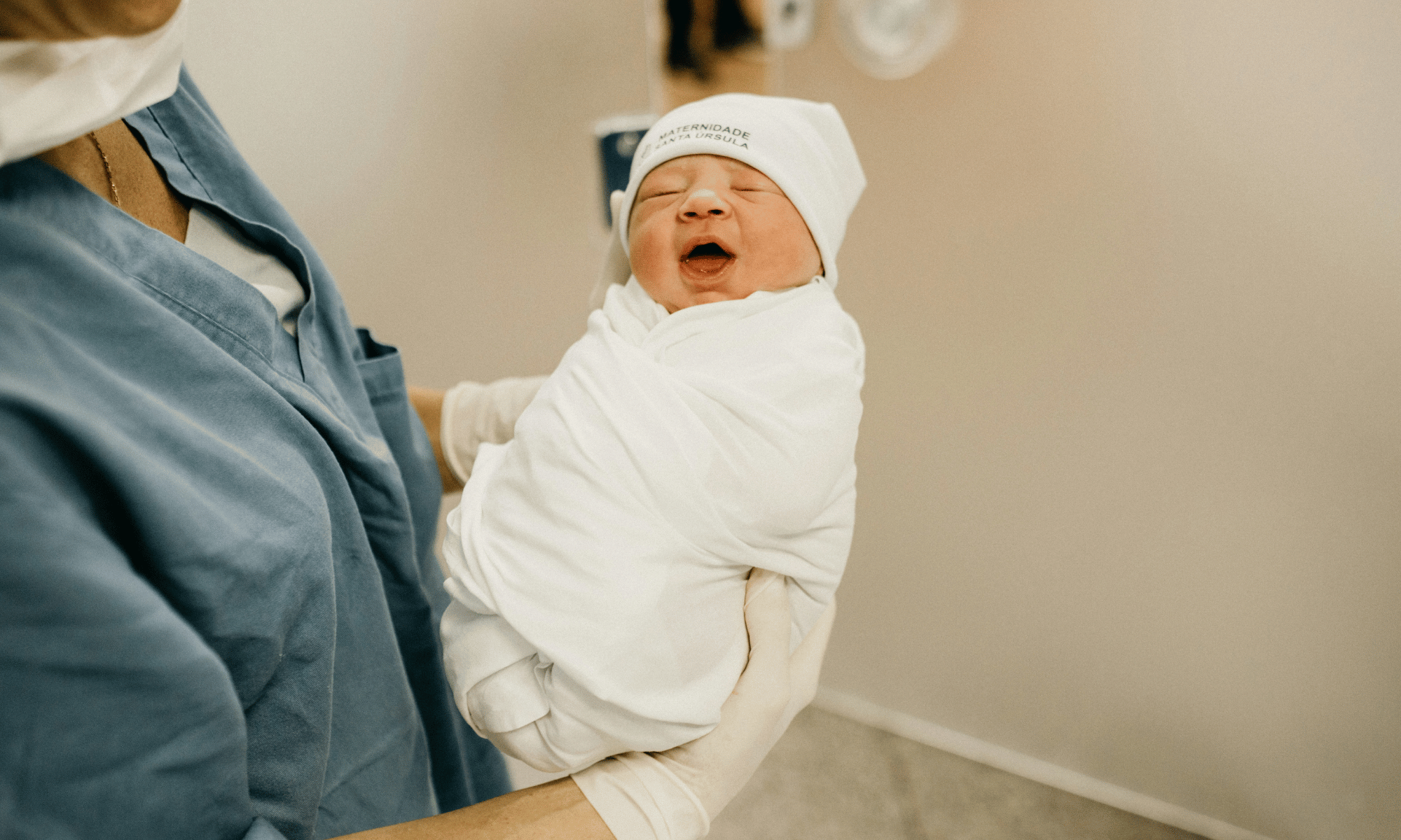 Nurse holding newborn baby