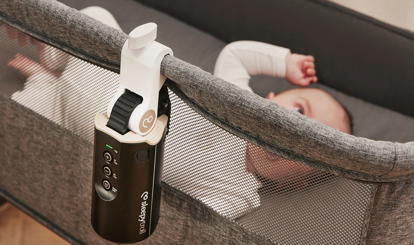 Baby laying in bassinet rocked by Sleepytroll Baby Rocker