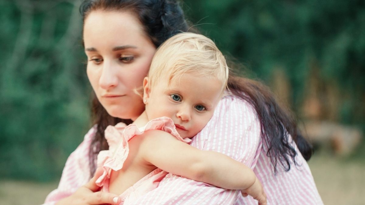 Mother holding her little girl in her arms