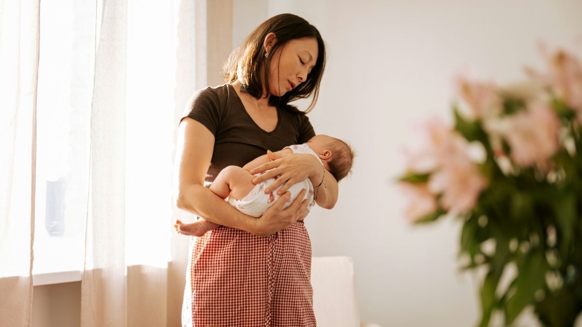 Mother rocking her baby to sleep in her arms